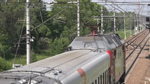 Passenger express train speeds up from the station Stock Footage 64943852