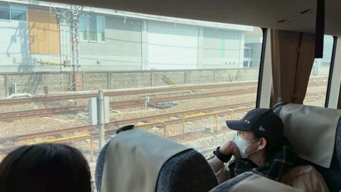 Passenger in Face Mask Looking Out Window of Kyoto Tourist Train Video stock 331898373