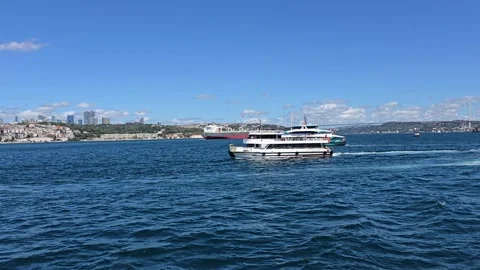 Passenger ferries and a cargo ship sail along the Bosphorus Strait in Istanbul Stock Footage 345603585