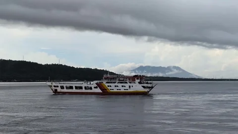 Passenger ferry with mount Merapi background, Bali Strait, Banyuwangi harbor. Video stock 311011837