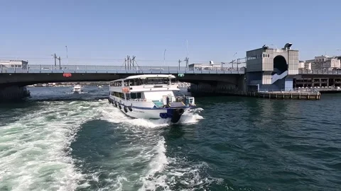 Passenger ferry passing under Galata Bridge on Golden Horn Istanbul Vídeos de archivo 331674144