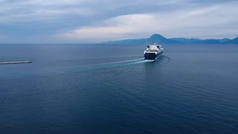 Passenger Ferry Sailing Toward Open Sea Near Mountain Coast Stock Footage 343993607