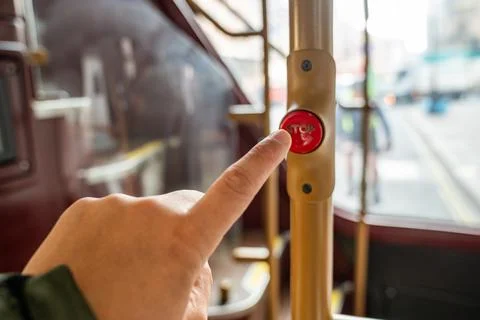 A Passenger Finger Pressing the Stop Button on a Red London Bus, Capturing .. Stock Photos