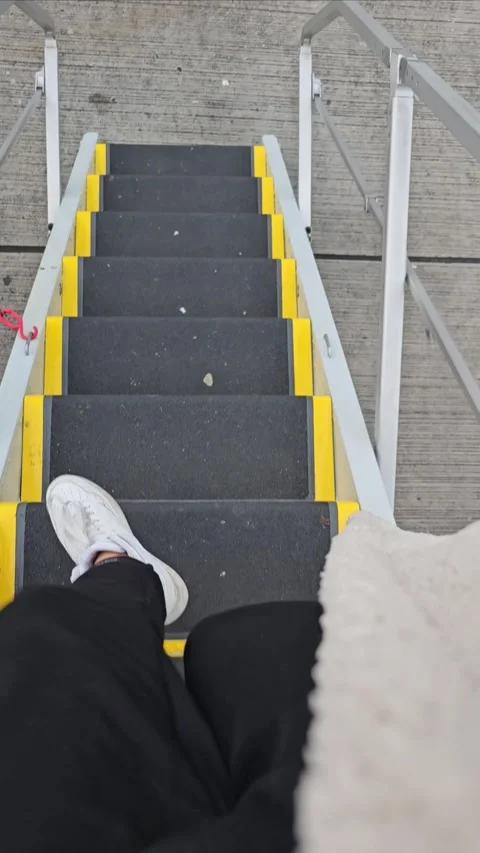 Passenger getting off the airplane ramp Stock Footage 287854589