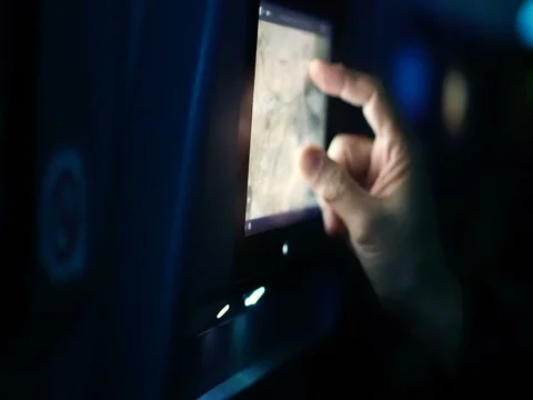 Passenger hand using airplane in flight touch screen to see flight detail map Stock Footage 74877214