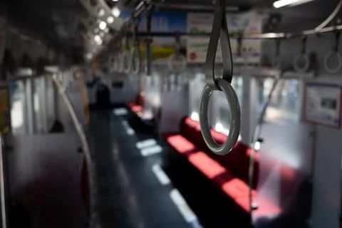 Passenger hanging strap inside train Stock Photos
