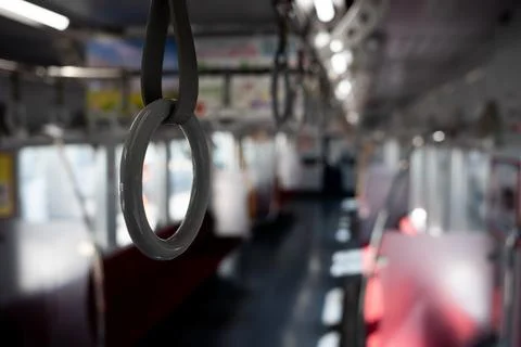 Passenger hanging strap inside the train Stock Photos