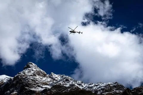 Passenger Helicopter Against Dramatic Alpine Backdrop Stock Photos