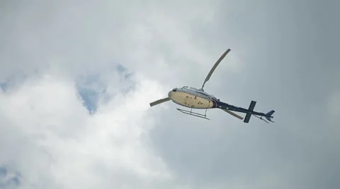 Passenger helicopter flying in the cloudy sky Stock Footage 40469282
