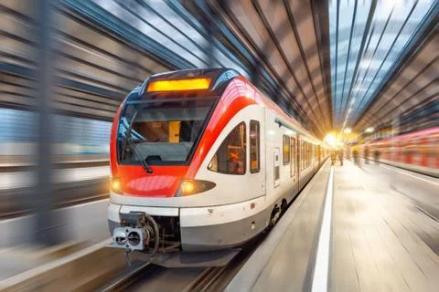 Passenger high speed train with motion blur in station. Stock Photos