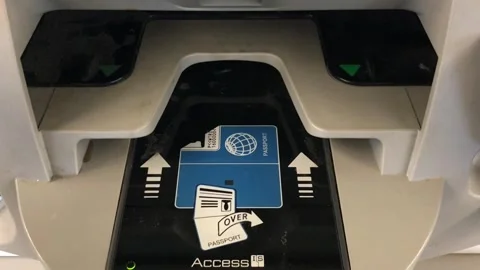 Passenger inserting passport and boarding pass into airport self check-in kiosk Stock Footage 317245735