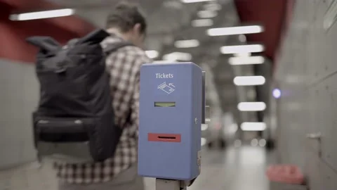 Passenger inserts ticket into validator to mark the time. Munich metro, subway Stock Footage 219950682