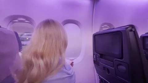 Passenger inside the airplane, preparing for takeoff Stock Photos