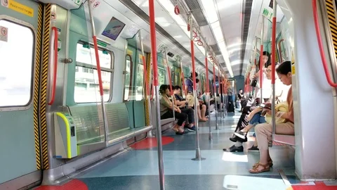 Passenger inside an MTR train on the East Rail Line Stock Footage 76596621