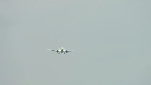 Passenger jet banking side to side in cloudy sky with landing gear down and Stock Footage 318452659