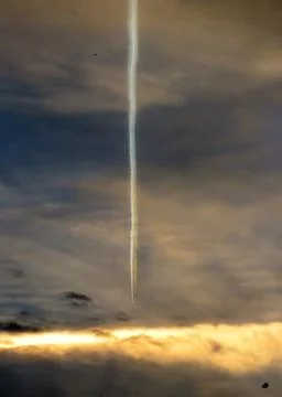Passenger Jet Contrail undergoing Vertical Effect Stock Photos