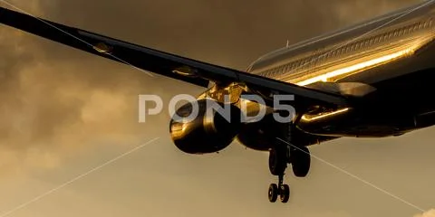Passenger Jet Landing Approach at Sunset Stock Photos
