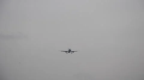 Passenger jet plane flying over airport runway against beautiful dusky sky use Stock Footage 54481636