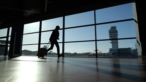 Passenger late and run in hurry, silhouette at airport, slow motion Stock Footage 320118166