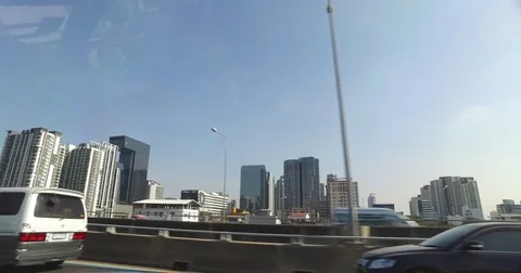 Passenger left side view pov shot of Bangkok traffic and buildings Stock Footage 74726331