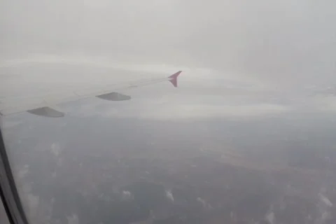 Passenger liner flying through clouds, airplane flight porthole, click for HD Stock Footage 43967825