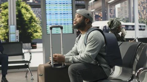 Passenger looking at shuttle station bus connections on departure board screen Stock Photos