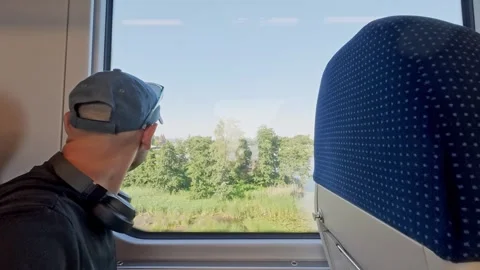 Passenger Looking Through Train Window During a Railway Journey in Poland Stock Footage 340020621