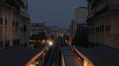 A passenger metro train departs an elevated station at dusk in Paris France Stock Footage 337243476