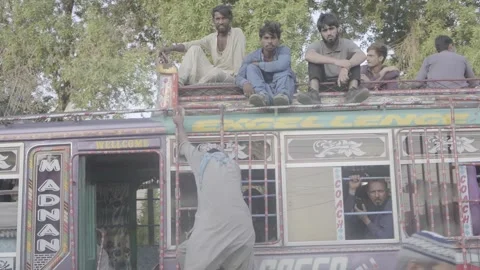 A passenger minibus and its passengers in Karachi, Pakistan Stock Footage 343875903