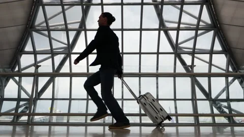 Passenger mixed up boarding time or confused gate, runs through empty airport Stock Footage 186419739