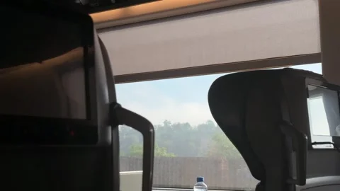 Passenger perspective inside modern train carriage, comfortable seat visible, 스톡 동영상 336630107