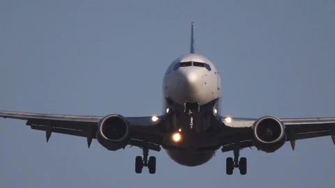 The passenger plane comes to land. Front view. There are pilots in the cockpit. Stock Footage 75048136