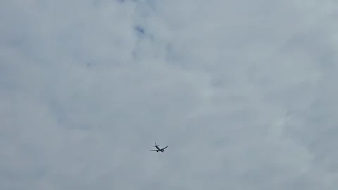 A passenger plane descends into a cloudy blue sky over Cordoba, Argentina. Stock Footage 335098561