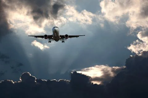 Passenger plane on final approach, against a stormy sky Stock Photos