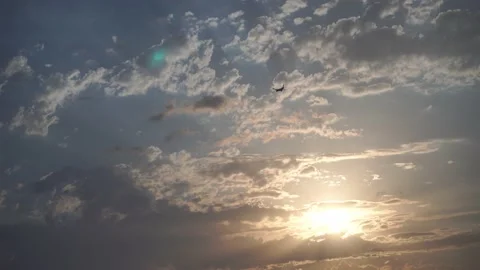 A passenger plane flies against the background of a sunset, cloudy sky Stock Footage 220720269
