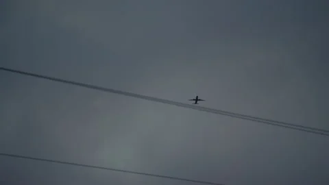 Passenger plane flies over power lines Stock Footage 243977096