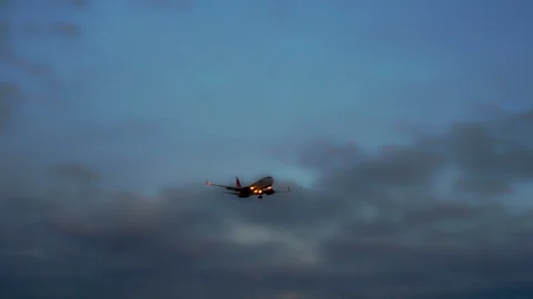 Passenger plane flies in the sky. In the background are thunderclouds. Stock Footage 105701891