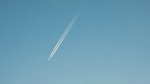 The passenger plane flies through the clear blue sunny sky Stock Footage 120316734