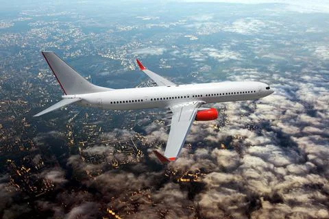 Passenger plane fly over the clouds. View from above. Stock Photos