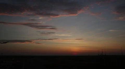 Passenger plane fly up over take-off runway from airport at sunset Stock Footage 54051821