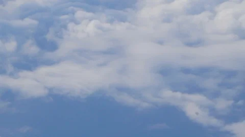 A passenger plane is flying in the blue sky with clouds. Video stock 101486408