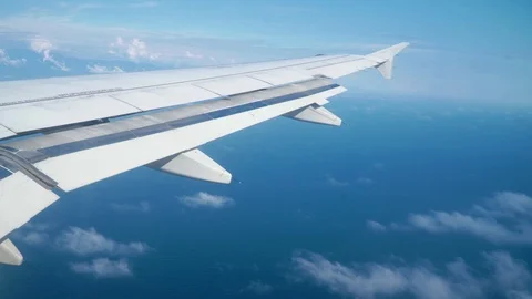 A passenger plane is flying in the blue sky with clouds. Stock Footage 101486782