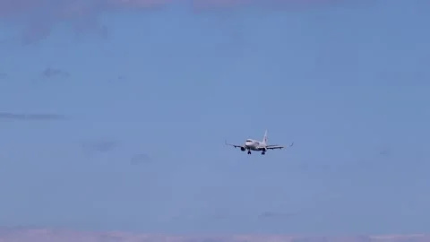 Passenger plane flying in blue sky Stock Footage 236726586
