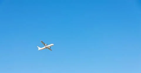 Passenger plane flying in the blue sky, cruise aircraft, transport industry Stock Photos
