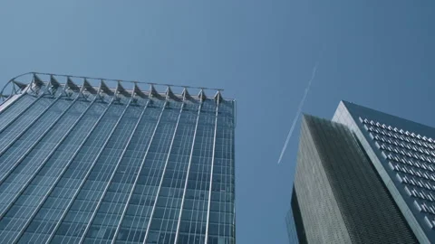 Passenger plane flying over two city buildings low angle Video stock 130294998