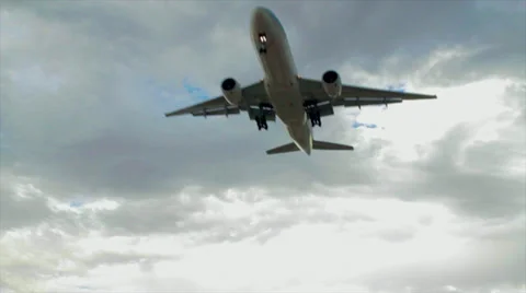 Passenger Plane Flying Overhead with Clouds Stock Footage