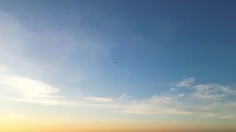 Passenger plane flying through the colorful sunset sky Stock Footage 323368331