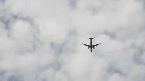 A passenger plane is going on a journey The plane is flying against a cloudy sky Stock Footage 220182433