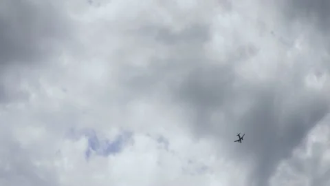 A passenger plane is going on a journey The plane is flying against a cloudy sky Stock Footage 220645877