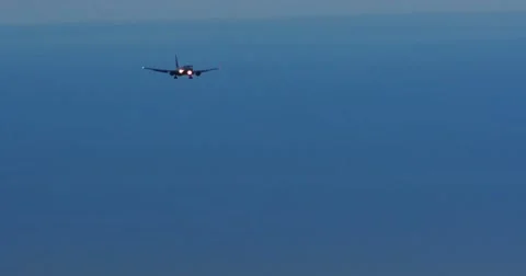 Passenger Plane Landing Against Dark Blue Morning Sky Vídeos de archivo 60992053